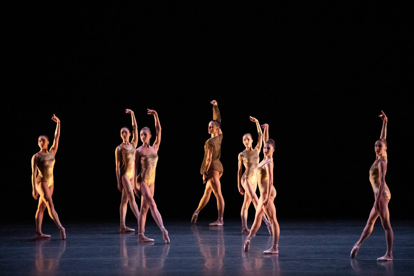 Dancers in tendu with one arm above their head